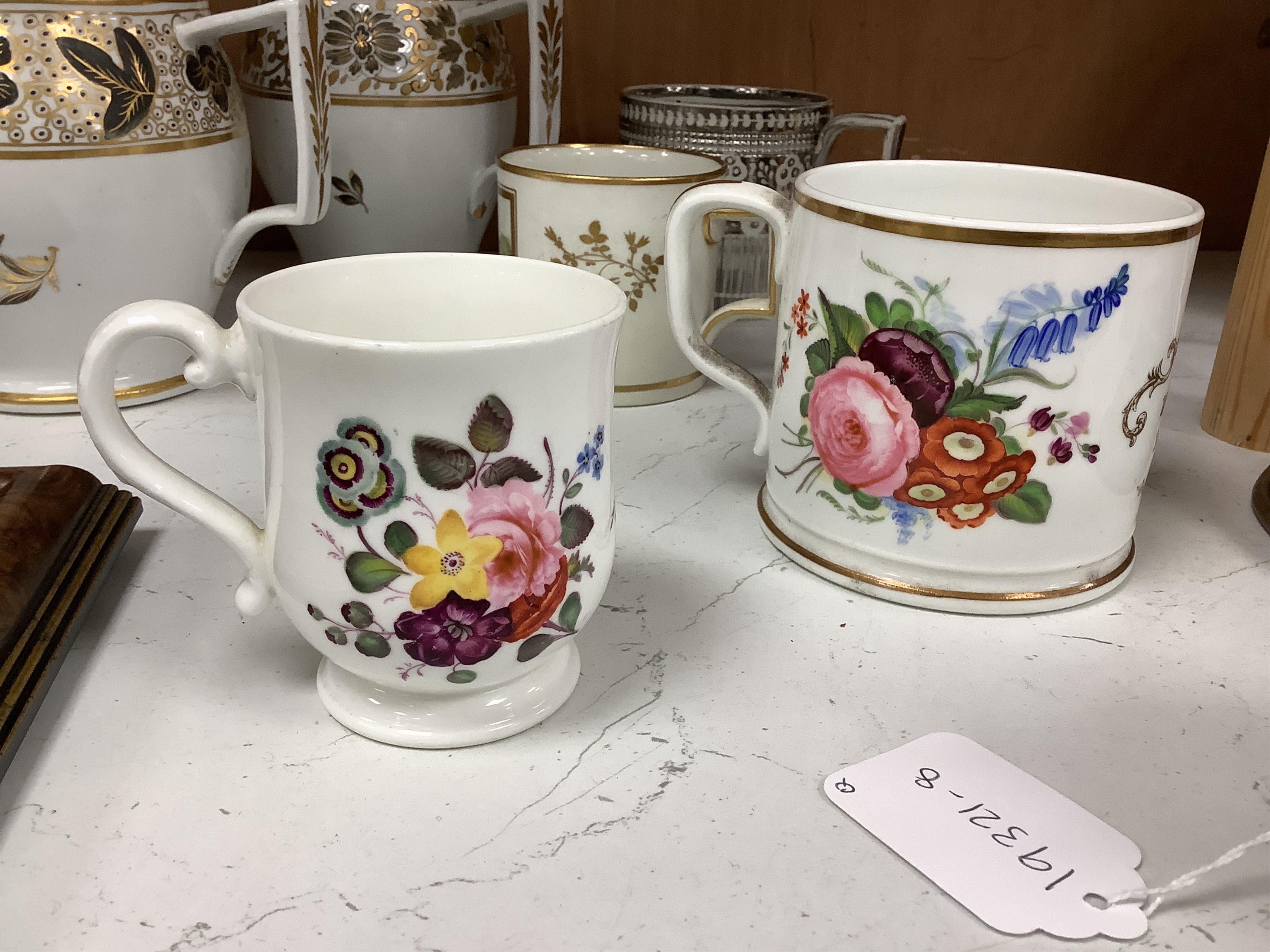 A pair of early 19th century English porcelain large mugs with gilt bands and five other early 19th century porcelain or pearlware mugs, one inscribed SG, Forget Me Not, largest each 14cm high